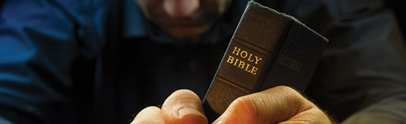 man holding bible